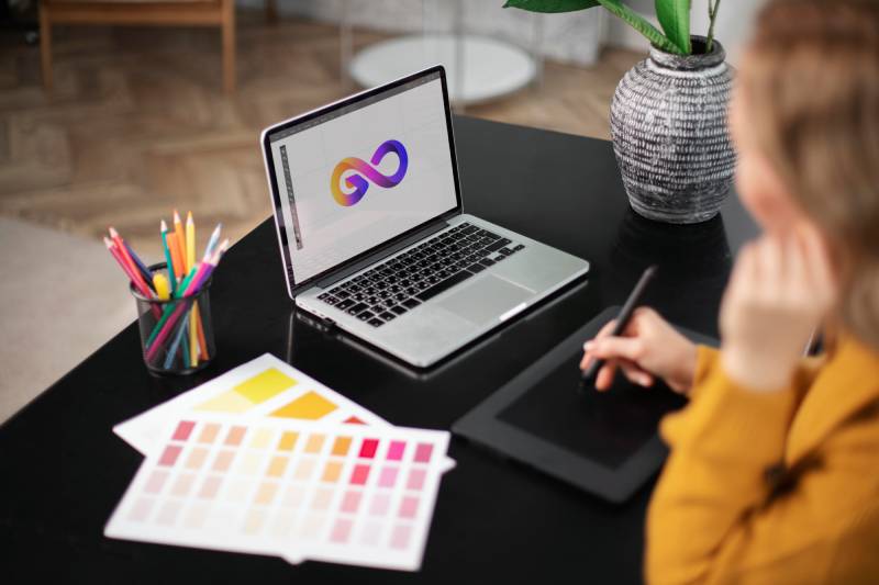 https://amversion.com/wp-content/uploads/2025/05/female-logo-designer-working-her-tablet-connected-laptop-1.jpg